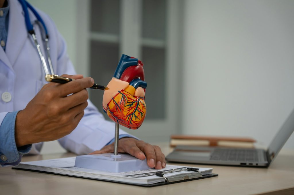 A male doctor sits at a desk in heart clinic, consulting onlinegiving advice.The vascular surgery