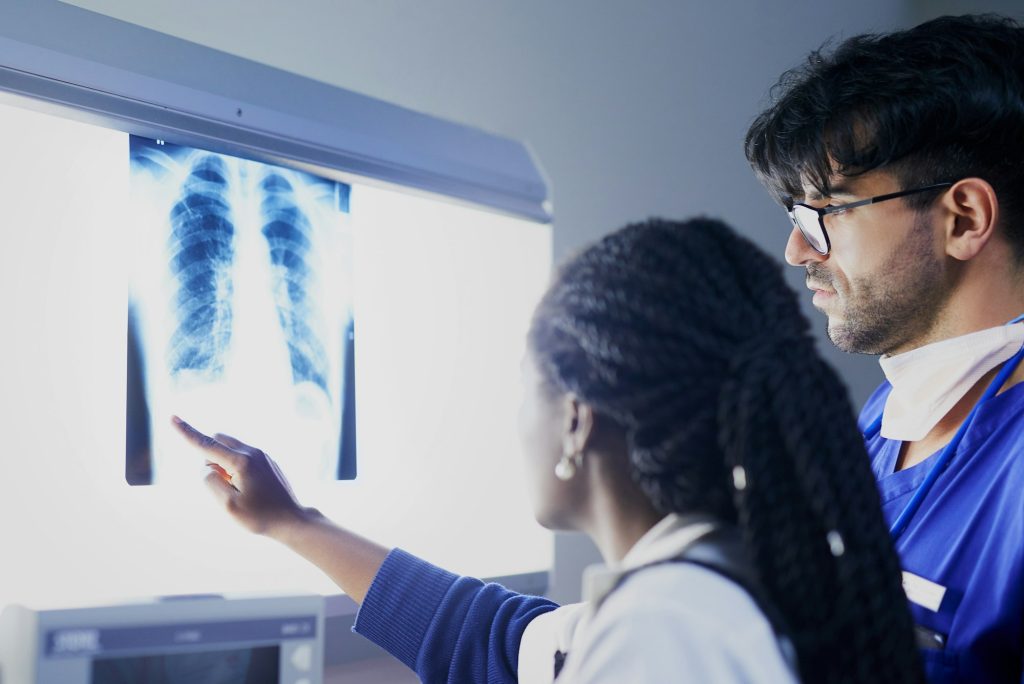 Shot of a team of surgeons discussing a patients x rays during surgery